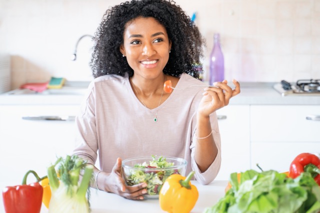 One black woman dieting and eating vegetables salad diet