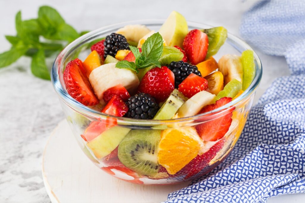 Delicious fruit salad on a plate on table.