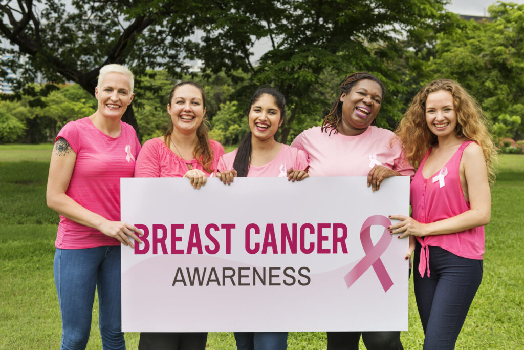 Women Holding A Breast Cancer Awareness Sign Outside