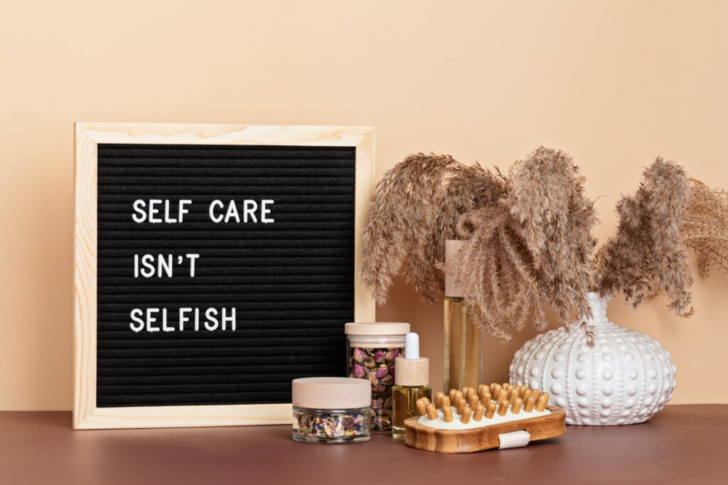 Self care is not selfish. Felt letter board with body and mind care products. Love yourself