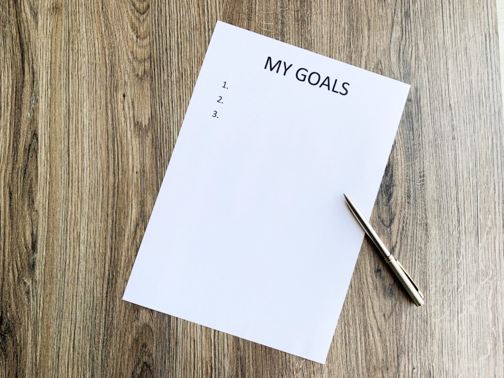 Clipboard with my goals on wood desk